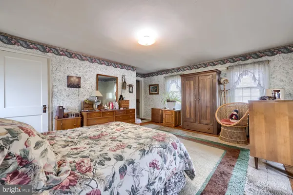 a bedroom with bed and wooden floor