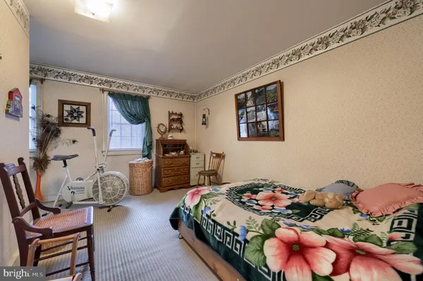 a bedroom with bed and a couch