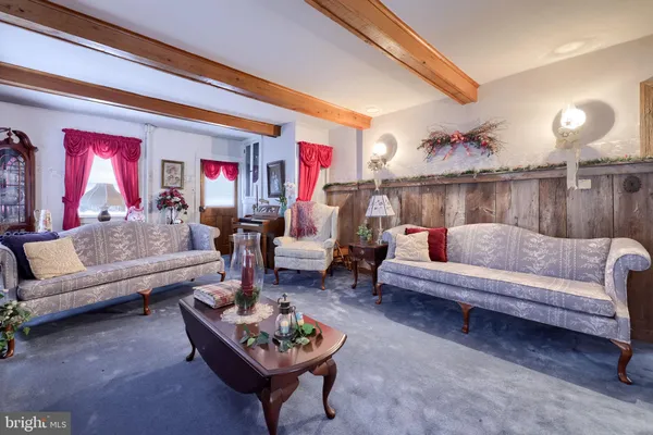 a living room with furniture and a chandelier