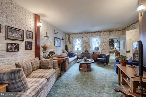 a living room with furniture fireplace and a large window