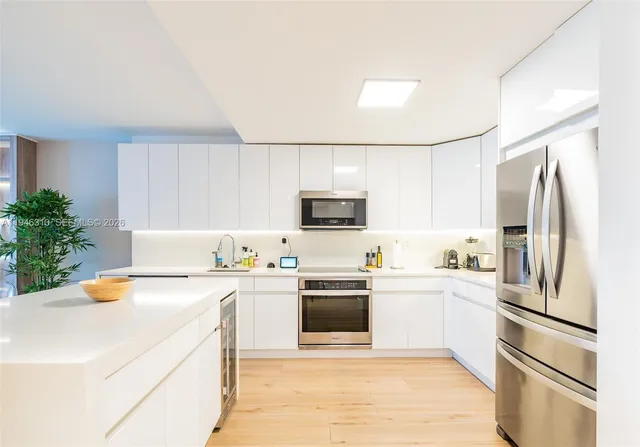 a kitchen with a sink a stove and refrigerator