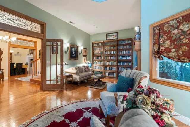 a bed sitting in a spacious bedroom next to a window