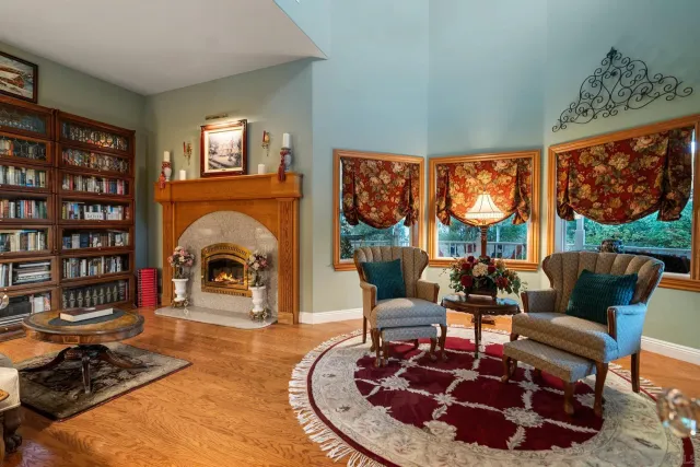 a bedroom with a bed and a lamp on dresser