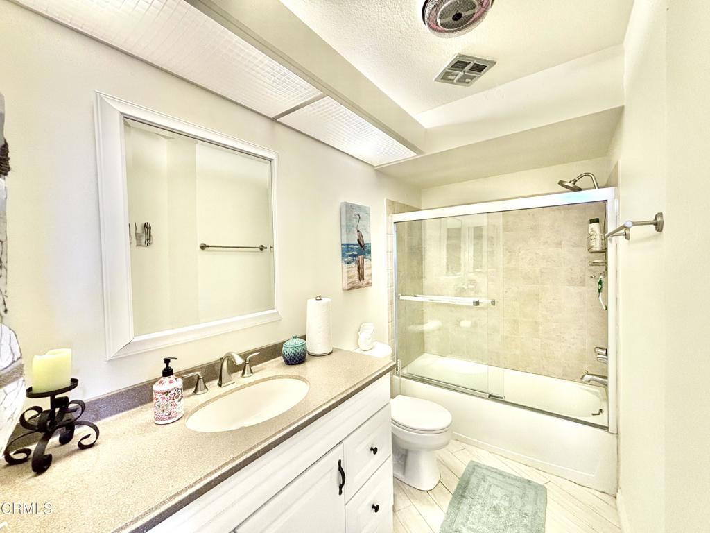 3101 Peninsula Road, Unit 312 Oxnard, CA 93035 - Photo 13 of 38 a bathroom with a granite countertop sink a toilet and shower