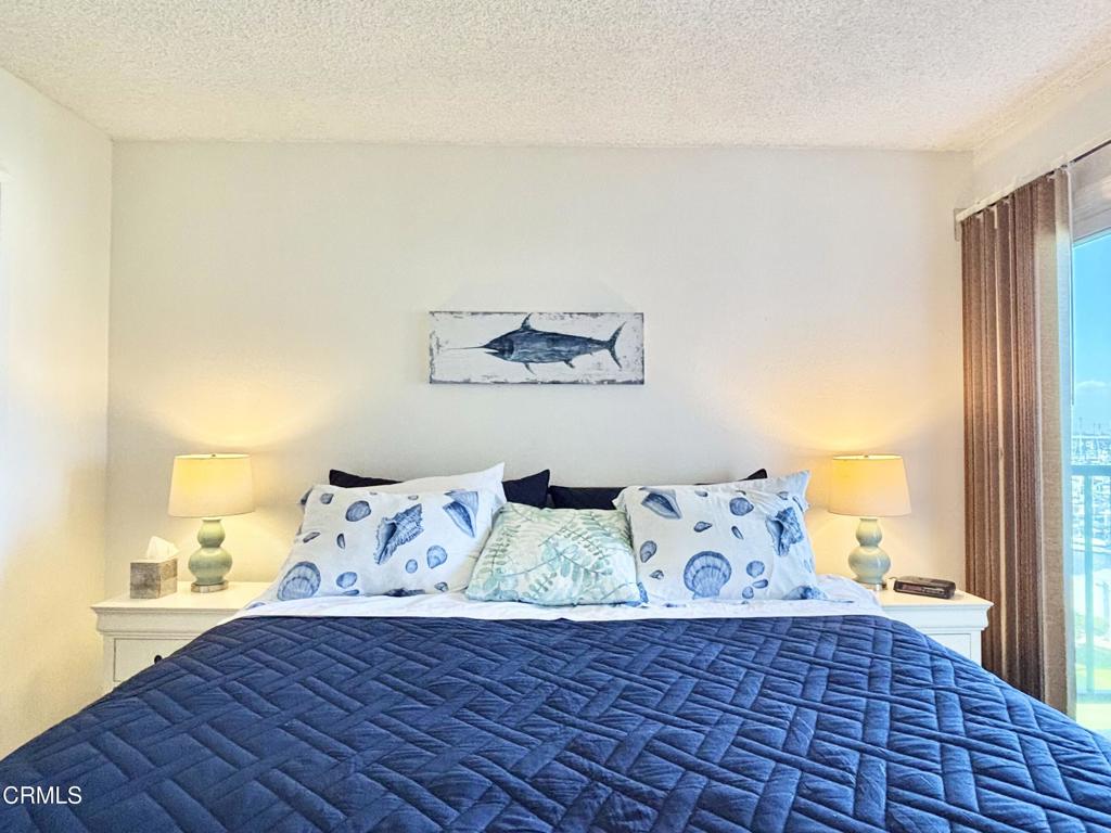3101 Peninsula Road, Unit 312 Oxnard, CA 93035 - Photo 15 of 38 a view of bedroom with furniture and wooden floor