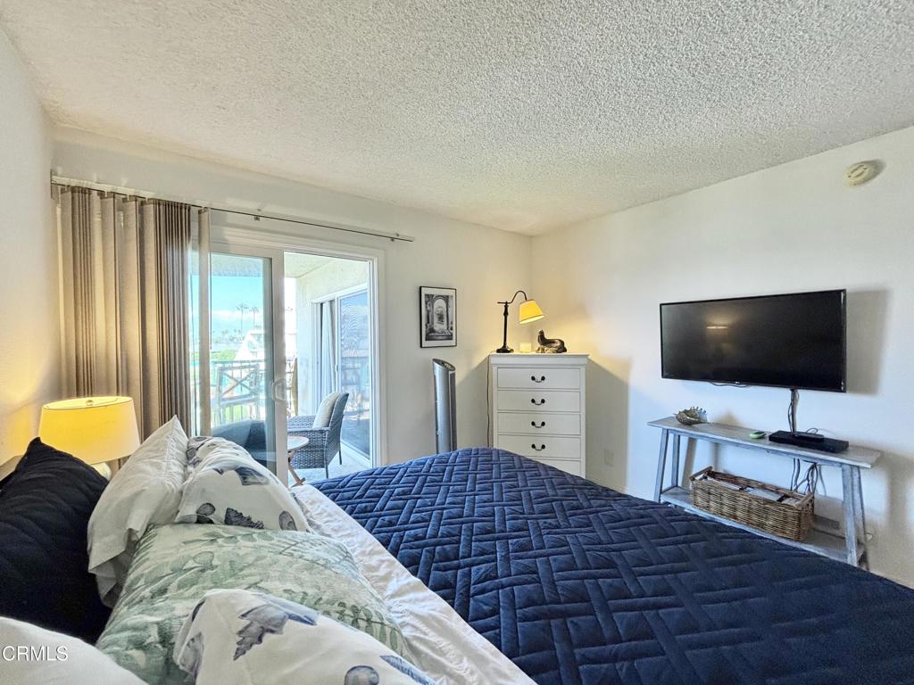 3101 Peninsula Road, Unit 312 Oxnard, CA 93035 - Photo 16 of 38 a bedroom with a bed and walk in closet with window