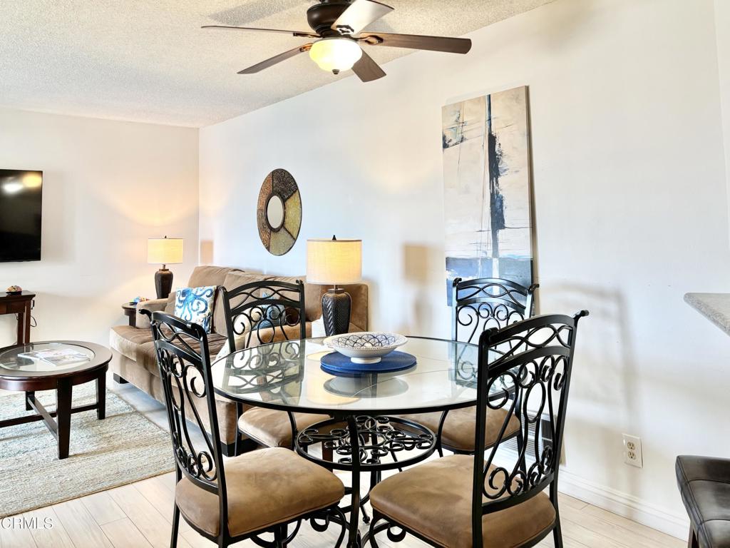 3101 Peninsula Road, Unit 312 Oxnard, CA 93035 - Photo 19 of 38 a view of a dining room with furniture and a chandelier