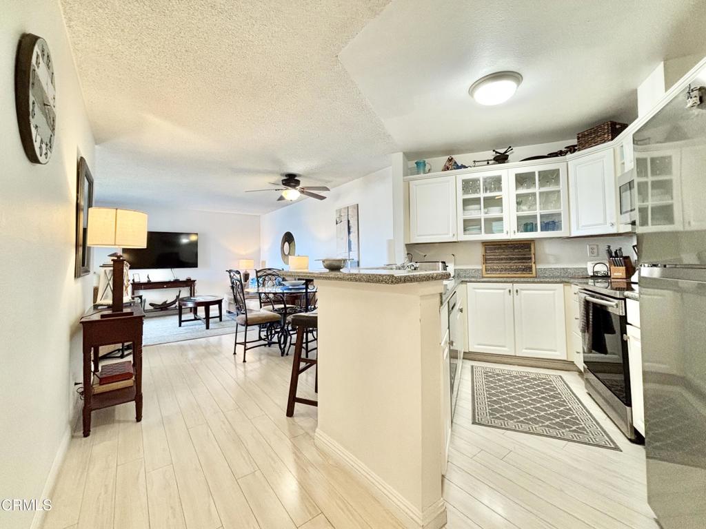 3101 Peninsula Road, Unit 312 Oxnard, CA 93035 - Photo 2 of 38 a living room with stainless steel appliances kitchen island granite countertop furniture and a kitchen view