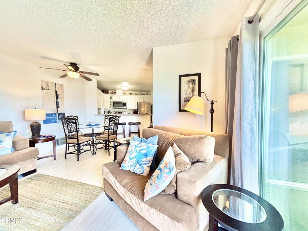 3101 Peninsula Road, Unit 312 Oxnard, CA 93035 - Photo 6 of 38 a living room with furniture and a wooden floor