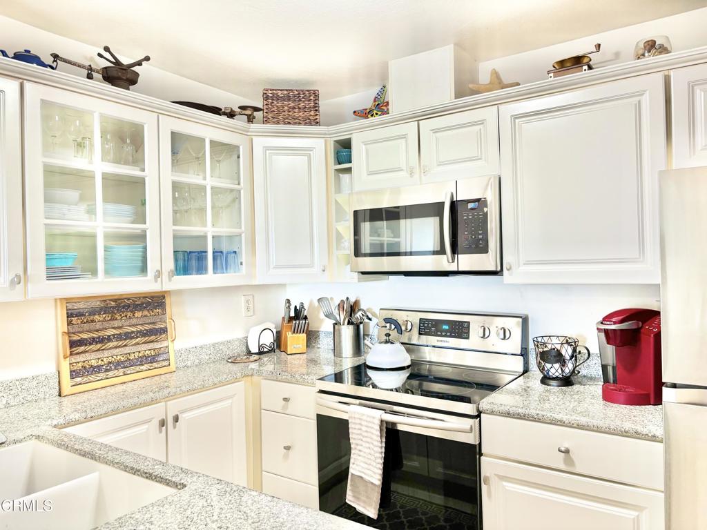 3101 Peninsula Road, Unit 312 Oxnard, CA 93035 - Photo 8 of 38 a kitchen with stainless steel appliances granite countertop a sink and cabinets