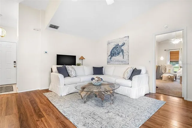 a living room with furniture and wooden floor