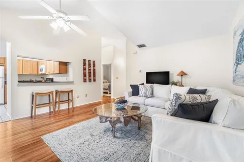 a living room with furniture and a wooden floor