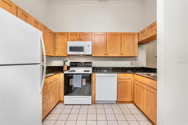 a kitchen with stainless steel appliances a stove a sink and a microwave