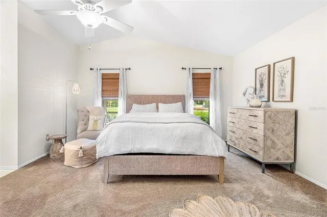 a spacious bedroom with a bed and a chandelier