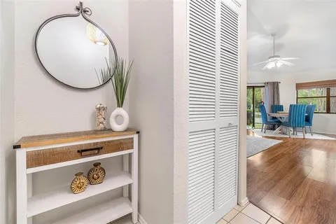 an entryway with wooden floor and a view of bathroom