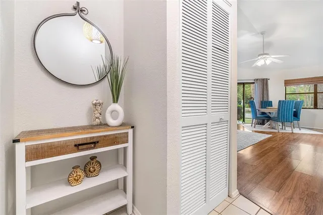 an entryway with wooden floor and a view of bathroom