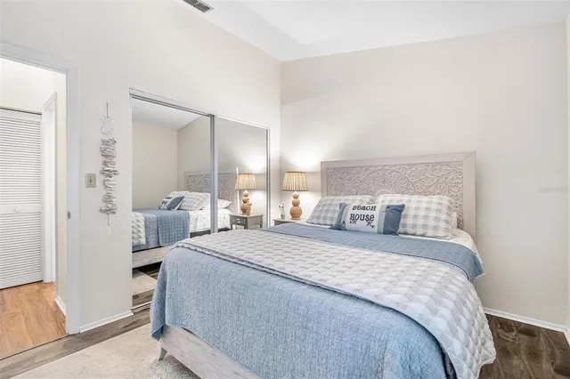 a bedroom with a bed and a mirror