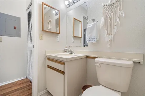 a bathroom with a sink toilet and mirror