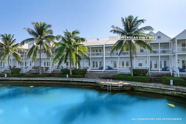 a view of swimming pool with outdoor seating and house in the background