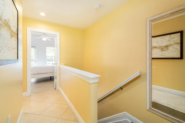 a large bed sitting in a bedroom next to a window