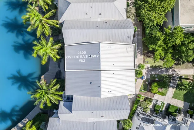 an aerial view of a house yard and swimming pool