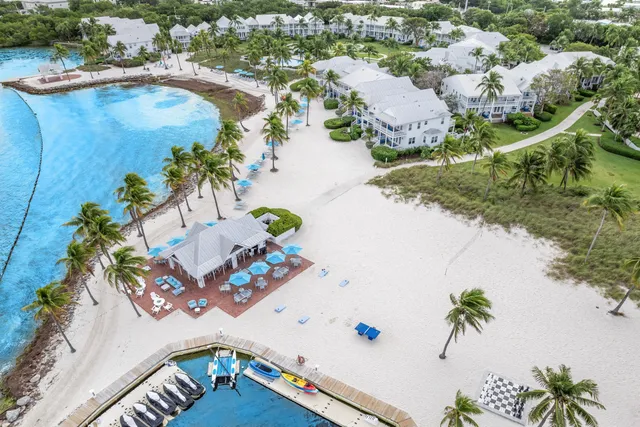 a view of a terrace with chairs and umbrella