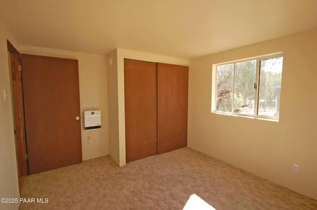 a living room with furniture and floor to ceiling windows