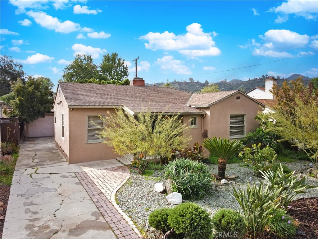 a view of a house with a yard and a garden