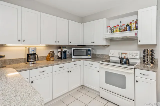 a kitchen with stainless steel appliances a stove microwave and cabinets