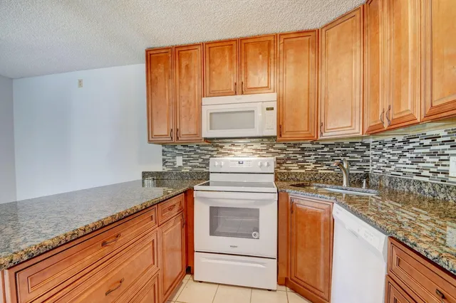 a kitchen with a refrigerator and cabinets