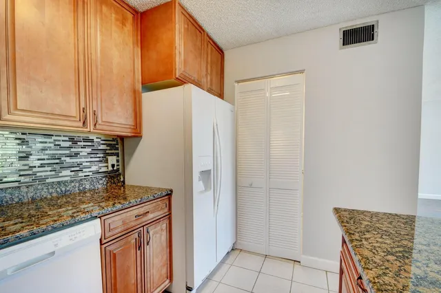 a bathroom with a granite countertop sink and a large mirror