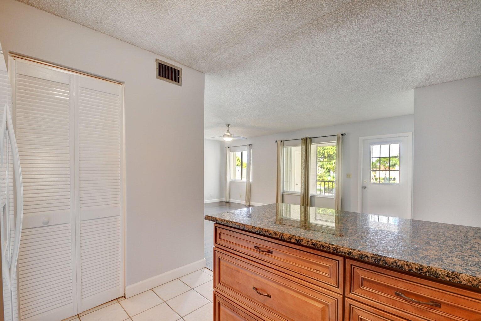 4844 Sable Pine Circle, Unit D2 West Palm Beach, FL 33417 - Photo 16 of 45 a bathroom with a granite countertop sink and a large mirror