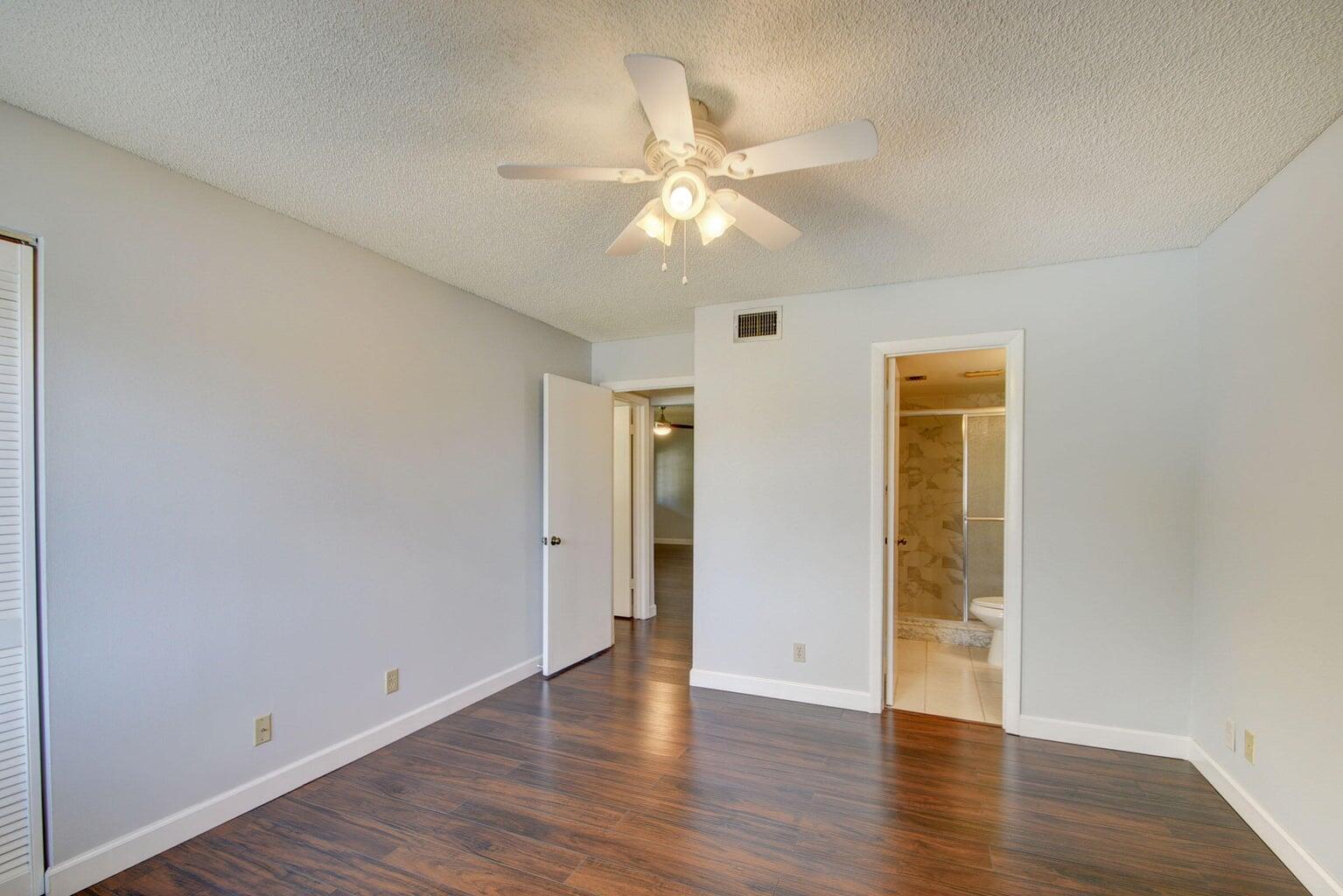 4844 Sable Pine Circle, Unit D2 West Palm Beach, FL 33417 - Photo 20 of 45 a view of an empty room with wooden floor