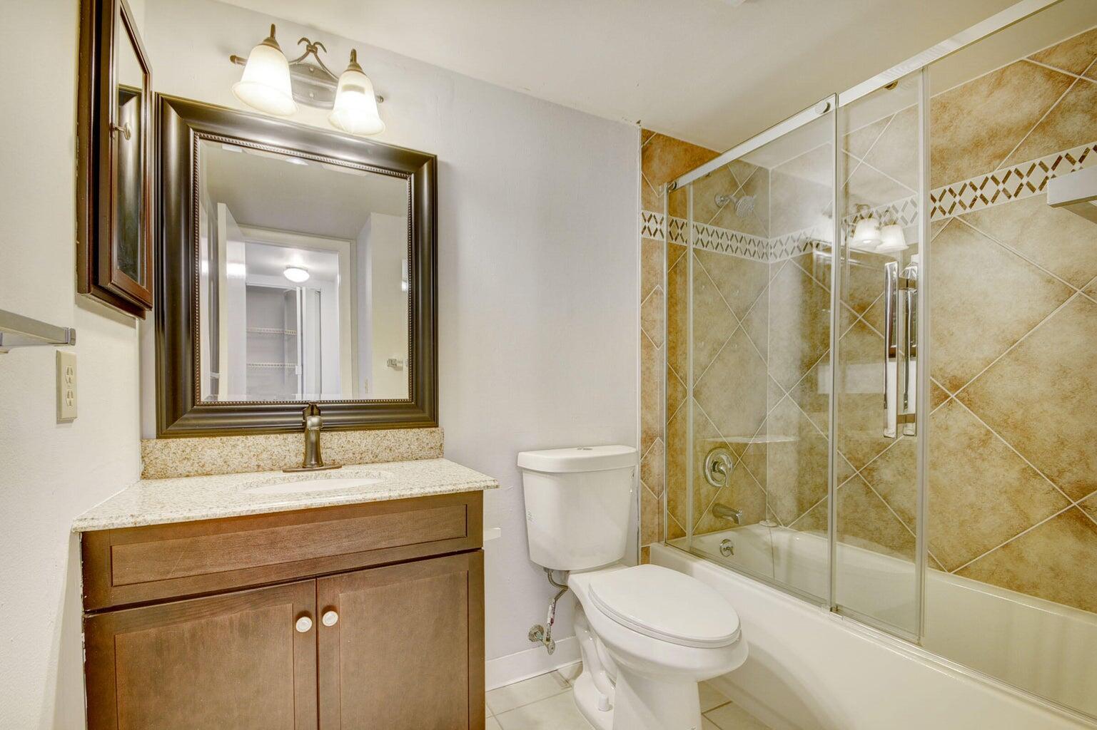 4844 Sable Pine Circle, Unit D2 West Palm Beach, FL 33417 - Photo 26 of 45 a bathroom with a sink toilet and shower