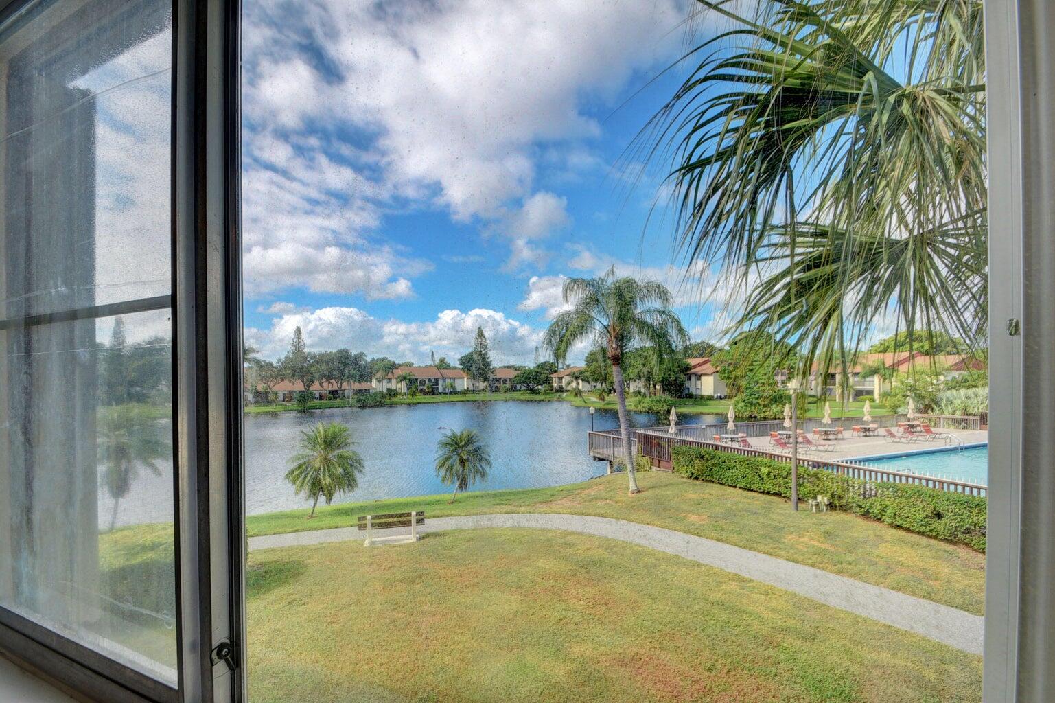 4844 Sable Pine Circle, Unit D2 West Palm Beach, FL 33417 - Photo 27 of 45 a view of a lake from a yard
