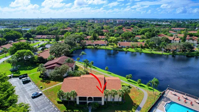 an aerial view of residential houses with outdoor space and lake view