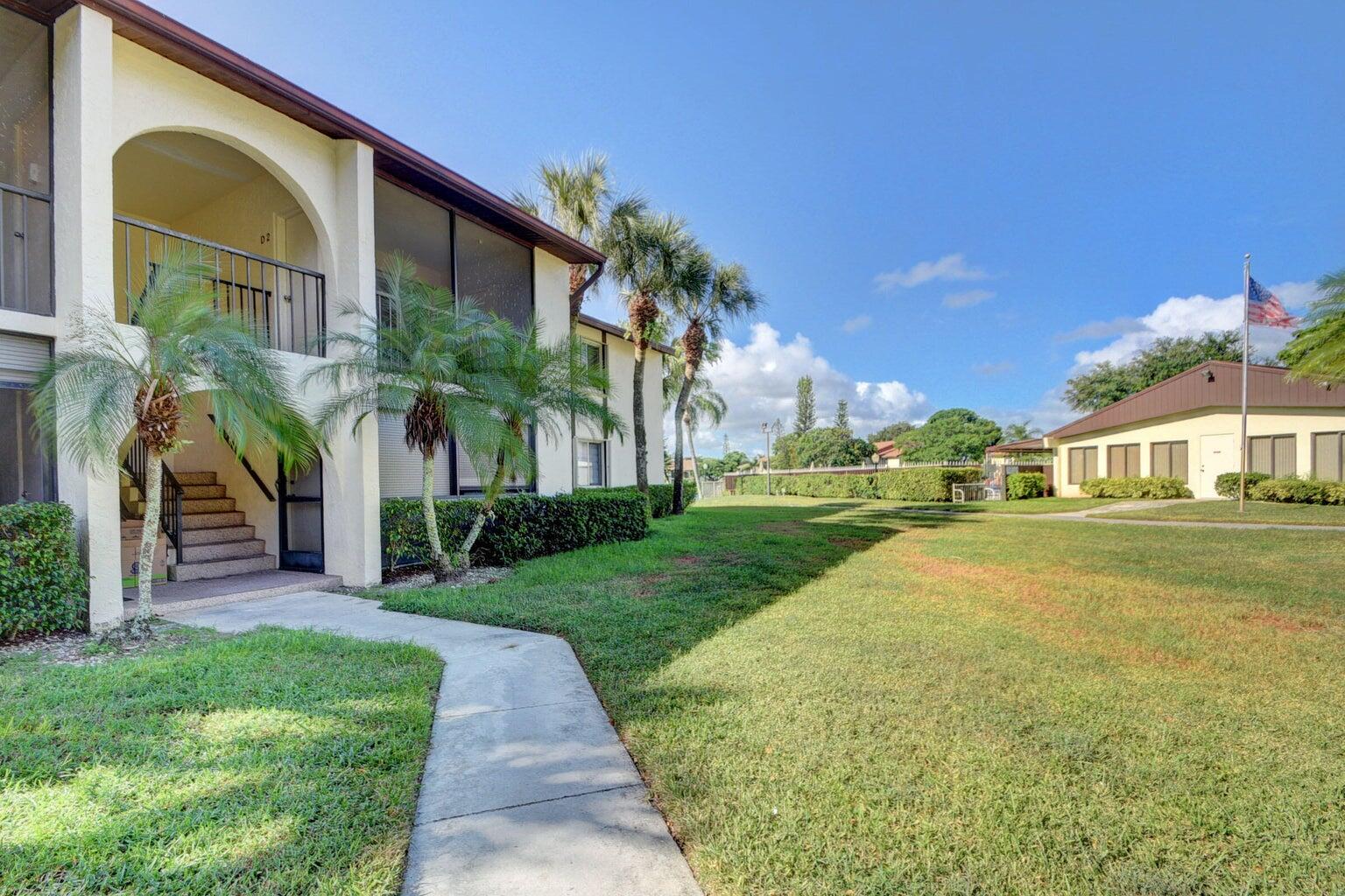 4844 Sable Pine Circle, Unit D2 West Palm Beach, FL 33417 - Photo 3 of 45 a front view of a house with a yard