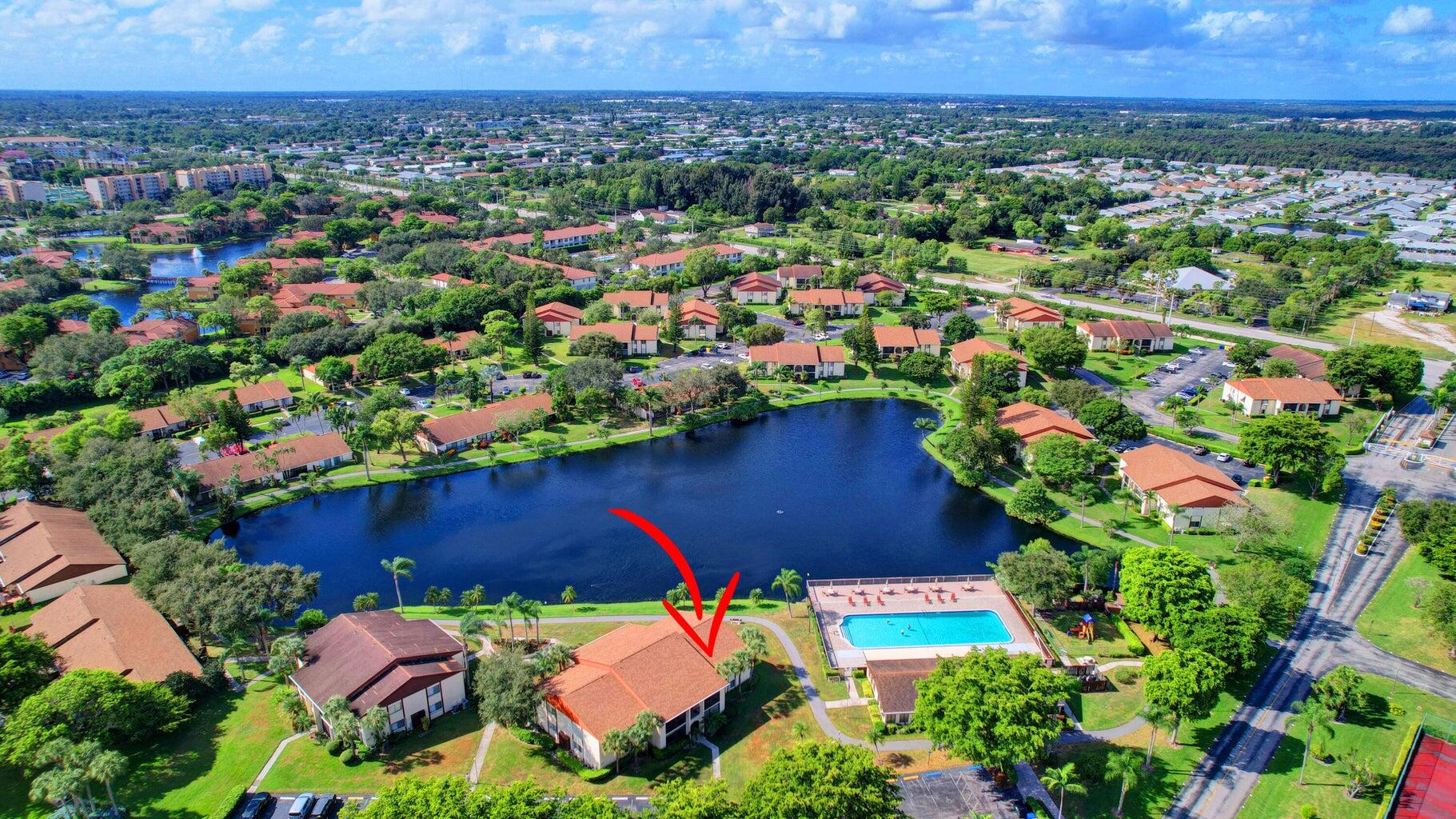 4844 Sable Pine Circle, Unit D2 West Palm Beach, FL 33417 - Photo 32 of 45 an aerial view of a house with a yard and lake view