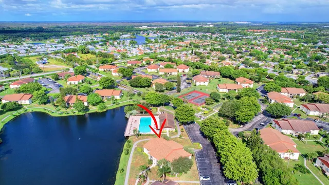 an aerial view of residential houses with outdoor space and street view
