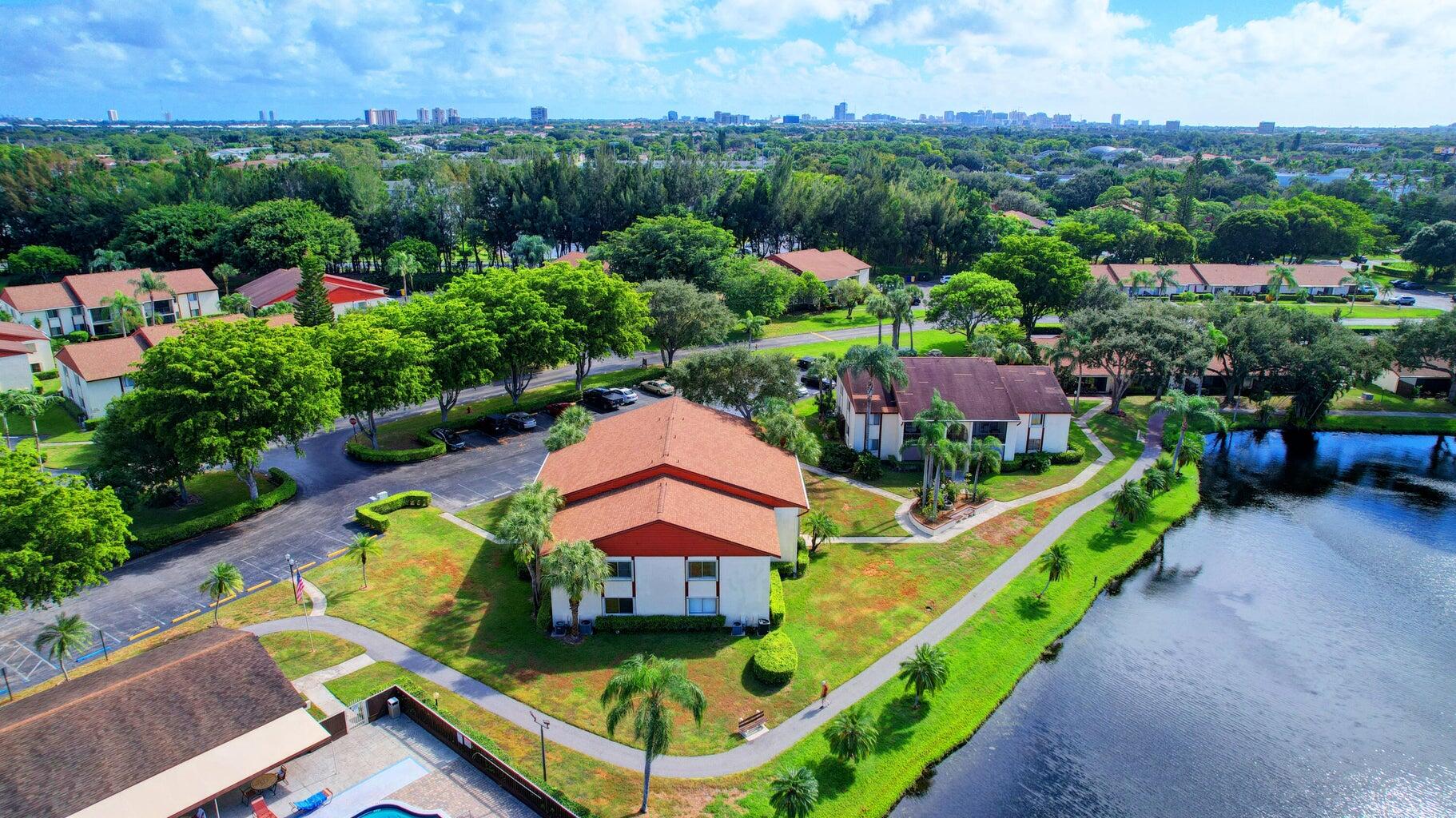 4844 Sable Pine Circle, Unit D2 West Palm Beach, FL 33417 - Photo 38 of 45 an aerial view of a house with a garden and lake view