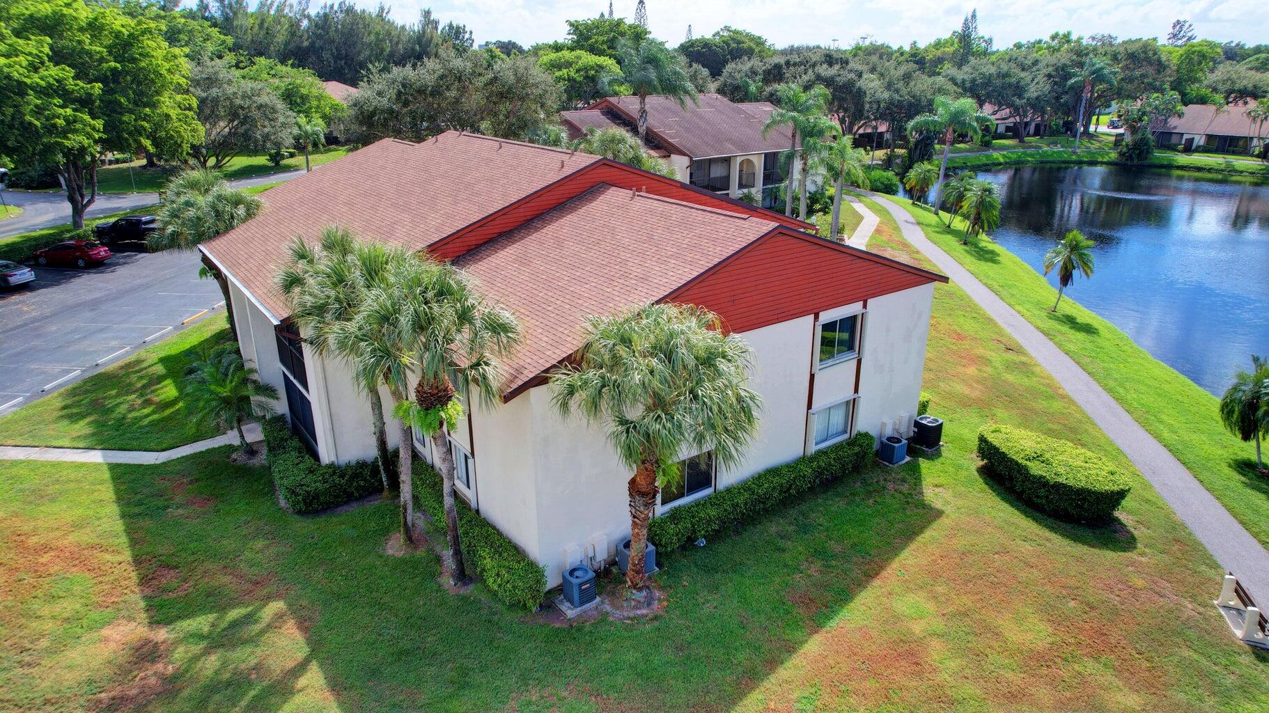 4844 Sable Pine Circle, Unit D2 West Palm Beach, FL 33417 - Photo 39 of 45 a view of a house with a yard and a patio