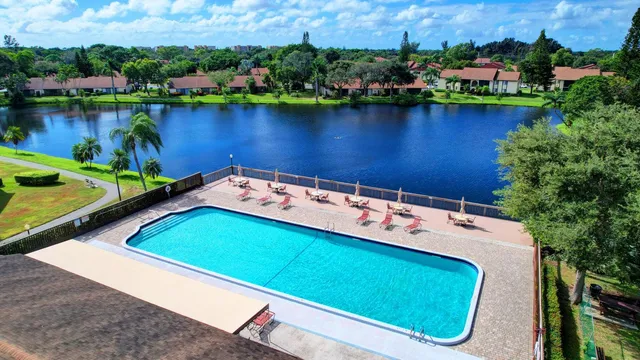 an aerial view of a house with swimming pool and deck