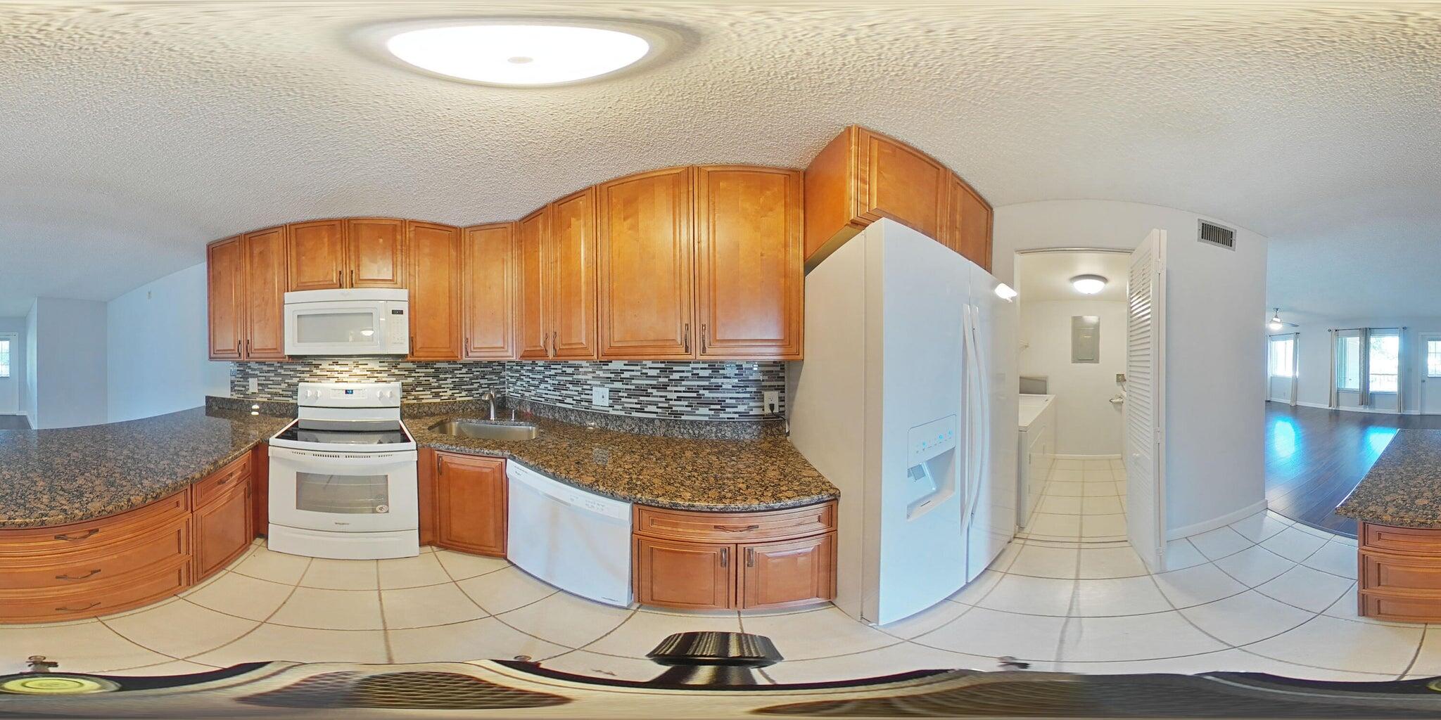 4844 Sable Pine Circle, Unit D2 West Palm Beach, FL 33417 - Photo 44 of 45 a kitchen with a sink and a stove