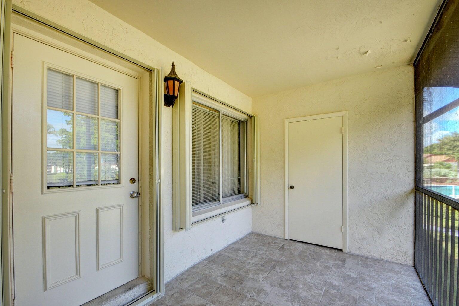4844 Sable Pine Circle, Unit D2 West Palm Beach, FL 33417 - Photo 6 of 45 an entryway with a glass door