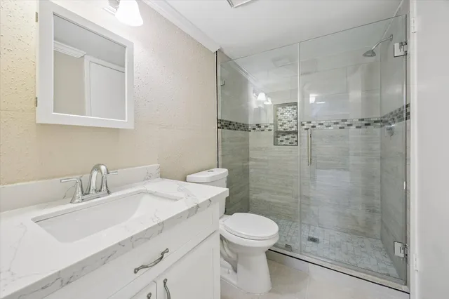 a bathroom with a sink toilet and shower