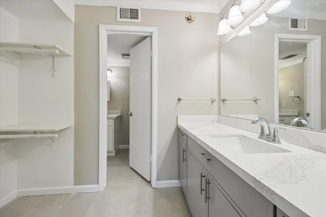 a bathroom with a double vanity sink a mirror and a shower
