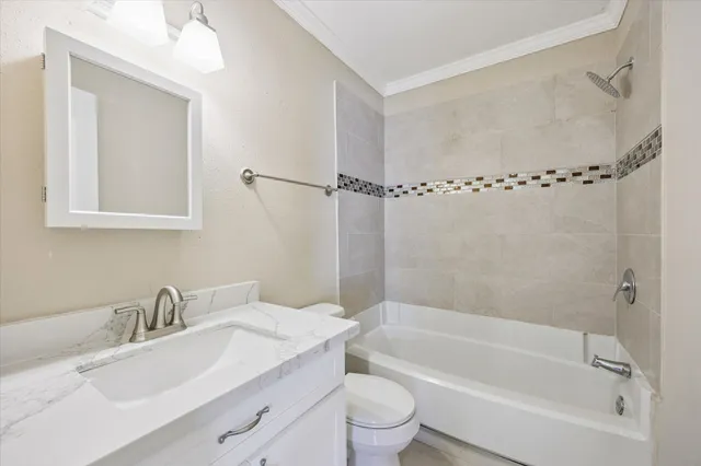a bathroom with a granite countertop sink a toilet and shower