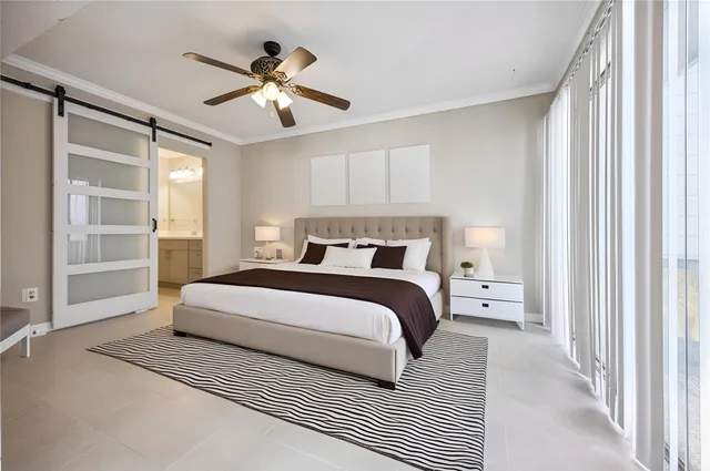 a bedroom with a large bed and a chandelier