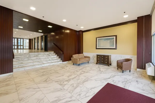 a view of a tall building next to a yard