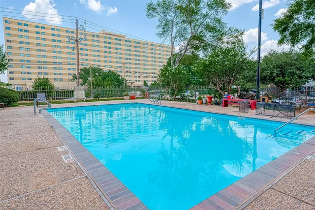 a view of a swimming pool with a patio and a patio
